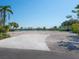 Wide brick driveway with view of waterfront homesite featuring lush tropical landscaping at 894 Freeling Dr, Sarasota, FL 34242