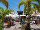 Relax at this outdoor seating area with colorful chairs, palm trees, and a tiki-themed setting at 894 Freeling Dr, Sarasota, FL 34242
