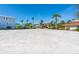 Spacious and sandy property lot, surrounded by lush palm trees and neighborhood houses at 894 Freeling Dr, Sarasota, FL 34242