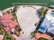Aerial view of an oversized waterfront lot with lush landscaping, ideal for building your dream home at 894 Freeling Dr, Sarasota, FL 34242