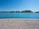Picturesque waterfront view featuring a brick seawall and lush landscaping along the coastline at 894 Freeling Dr, Sarasota, FL 34242