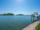 Peaceful waterfront view featuring a boat lift with calm waters and island scenery at 894 Freeling Dr, Sarasota, FL 34242