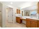 Bathroom featuring double sink vanity, large mirror, and walk-in shower at 9307 Raes Creek Pl, Palmetto, FL 34221