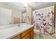 Bright bathroom featuring vanity and shower with floral patterned shower curtain at 9307 Raes Creek Pl, Palmetto, FL 34221