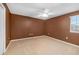 Empty bedroom with neutral carpet, a ceiling fan, and natural light from the window at 9307 Raes Creek Pl, Palmetto, FL 34221