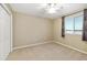 Bedroom showcasing neutral carpet, a ceiling fan, and a window providing natural light at 9307 Raes Creek Pl, Palmetto, FL 34221