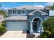 Charming two-story home with an arched entryway, beautiful paint and mature landscaping at 9307 Raes Creek Pl, Palmetto, FL 34221