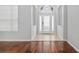 Bright foyer with decorative glass front door, arched transom window and beautiful wood flooring at 9307 Raes Creek Pl, Palmetto, FL 34221