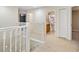 Bright hallway with neutral carpet, white trim and doors, and easy access to the bathroom and bedrooms at 9307 Raes Creek Pl, Palmetto, FL 34221