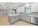 Bright kitchen features white cabinets, stainless steel appliances, and modern backsplash at 9307 Raes Creek Pl, Palmetto, FL 34221