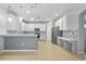 A large kitchen featuring updated stainless steel appliances, white cabinets, tile floors, and a breakfast bar at 9307 Raes Creek Pl, Palmetto, FL 34221