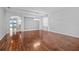Open living room with modern chandelier, neutral paint, and sliding doors to the outside at 9307 Raes Creek Pl, Palmetto, FL 34221
