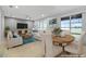 Bright living room featuring neutral tones, ceiling fan, large windows and sliding door access to an outdoor pool at 9307 Raes Creek Pl, Palmetto, FL 34221