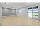 Spacious living room with ceramic tile flooring and sliding glass doors to the lanai at 9307 Raes Creek Pl, Palmetto, FL 34221