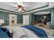 An inviting main bedroom leads to an ensuite and sitting area with calming green walls at 9307 Raes Creek Pl, Palmetto, FL 34221