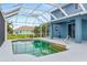 Screened-in in-ground pool, covered patio, and backyard at 9307 Raes Creek Pl, Palmetto, FL 34221
