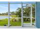 View from the screened-in porch shows green vegetation and the waterfront at 9307 Raes Creek Pl, Palmetto, FL 34221