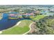 Aerial view of condo building surrounded by lush golf course and sparkling lakes at 9320 Clubside Cir # 2208, Sarasota, FL 34238