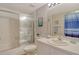 Bright bathroom features a shower-tub combo, vanity with sink, and coastal-themed decorations at 9320 Clubside Cir # 2208, Sarasota, FL 34238