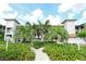 Well-maintained building exterior with lush landscaping and a sidewalk at 9320 Clubside Cir # 2208, Sarasota, FL 34238