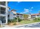 Exterior view of condo building featuring well-maintained landscaping and multiple floors at 9320 Clubside Cir # 2208, Sarasota, FL 34238