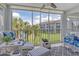Cozy lanai featuring comfortable seating and serene views of the surrounding lush landscape at 9320 Clubside Cir # 2208, Sarasota, FL 34238