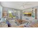 Comfortable living room with a plush sofa, entertainment center, and access to a cozy lanai at 9320 Clubside Cir # 2208, Sarasota, FL 34238