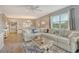 Bright living room features a large sectional sofa, ceiling fan, and beautiful views at 9320 Clubside Cir # 2208, Sarasota, FL 34238