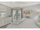 The primary bedroom features coastal decor, a ceiling fan, and a balcony at 9320 Clubside Cir # 2208, Sarasota, FL 34238