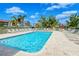 Community pool surrounded by tropical plants and chairs, perfect for relaxation at 9320 Clubside Cir # 2208, Sarasota, FL 34238