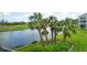 Scenic view of the lake, golf course, and tropical palm trees at 9320 Clubside Cir # 2208, Sarasota, FL 34238