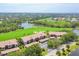 Aerial view of the community with golf course, water features, and lush green spaces at 9641 Castle Point Dr # 1215, Sarasota, FL 34238