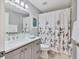 Stylish bathroom with a sleek vanity, modern fixtures, and a shower with decorative curtain at 9641 Castle Point Dr # 1215, Sarasota, FL 34238