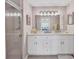 Updated bathroom with white cabinetry, stone countertops, and glass enclosed shower at 9641 Castle Point Dr # 1215, Sarasota, FL 34238