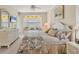Comfortable bedroom with a bay window, golf course views, and neutral decor at 9641 Castle Point Dr # 1215, Sarasota, FL 34238