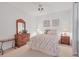 Cozy bedroom with a queen-sized bed, dresser, nightstands, and charming decor accents at 9641 Castle Point Dr # 1215, Sarasota, FL 34238