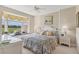 Comfortable bedroom with a large window seat overlooking a golf course at 9641 Castle Point Dr # 1215, Sarasota, FL 34238
