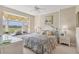 Comfortable bedroom with golf course views, a bay window, and neutral decor at 9641 Castle Point Dr # 1215, Sarasota, FL 34238