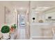 Inviting entryway showcasing a tiled floor, decorative art, and an open view to the kitchen and beyond at 9641 Castle Point Dr # 1215, Sarasota, FL 34238