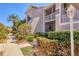 Beautifully landscaped condo exterior with a sidewalk, mature trees and a well-maintained facade at 9641 Castle Point Dr # 1215, Sarasota, FL 34238