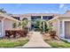 Inviting condo exterior featuring manicured landscaping and a charming walkway leading to the entrance at 9641 Castle Point Dr # 1215, Sarasota, FL 34238