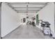 Spacious garage interior with overhead storage, bike, ladder and outdoor grill at 9641 Castle Point Dr # 1215, Sarasota, FL 34238