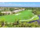Scenic view of a meticulously maintained golf course with lush green fairways and a serene pond at 9641 Castle Point Dr # 1215, Sarasota, FL 34238
