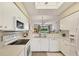 Modern white kitchen featuring ample cabinet space and stainless steel appliances at 9641 Castle Point Dr # 1215, Sarasota, FL 34238