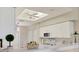 Bright kitchen features white cabinetry, modern appliances, and an elegant ceiling fan with natural light at 9641 Castle Point Dr # 1215, Sarasota, FL 34238