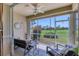 Enclosed lanai with comfortable seating overlooking a green golf course at 9641 Castle Point Dr # 1215, Sarasota, FL 34238
