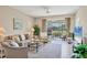 Cozy living room with comfortable seating, neutral tones, and a view of the screened lanai at 9641 Castle Point Dr # 1215, Sarasota, FL 34238