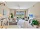 Open-concept living area with ample seating, a ceiling fan, and a large window with scenic views at 9641 Castle Point Dr # 1215, Sarasota, FL 34238