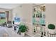 Bright living room showcasing a mirrored shelving unit, neutral décor, and access to the outdoors at 9641 Castle Point Dr # 1215, Sarasota, FL 34238