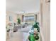 Bright and airy living room featuring tile floors, comfortable seating, and a view of the outdoors at 9641 Castle Point Dr # 1215, Sarasota, FL 34238